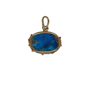 Persian Turquoise pendant set in sterling silver with 14k yellow gold accents.