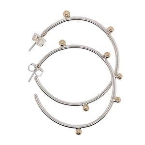 Dreamcatcher hoop earrings in sterling silver with gold accents.