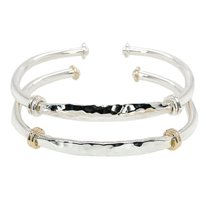 Hammered cuff bracelet in sterling silver and sterling silver with gold accents.
