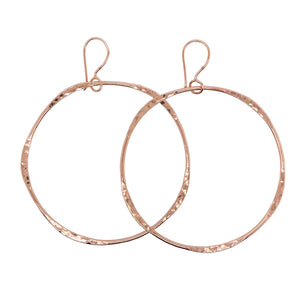 Hammered hoop earrings in rose gold.