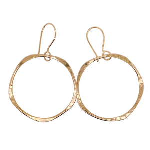 Hammered hoop earrings in gold.