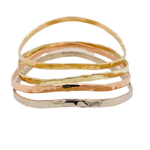 Hammered bangle in sterling silver, gold, and rose gold.