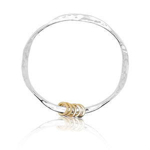 Jingle jangle bangle in sterling silver with 14k yellow gold rings