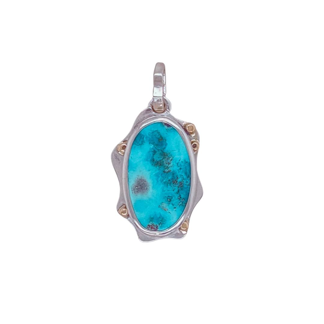 ersian Turquoise pendant set in sterling silver with 14k yellow gold accents.