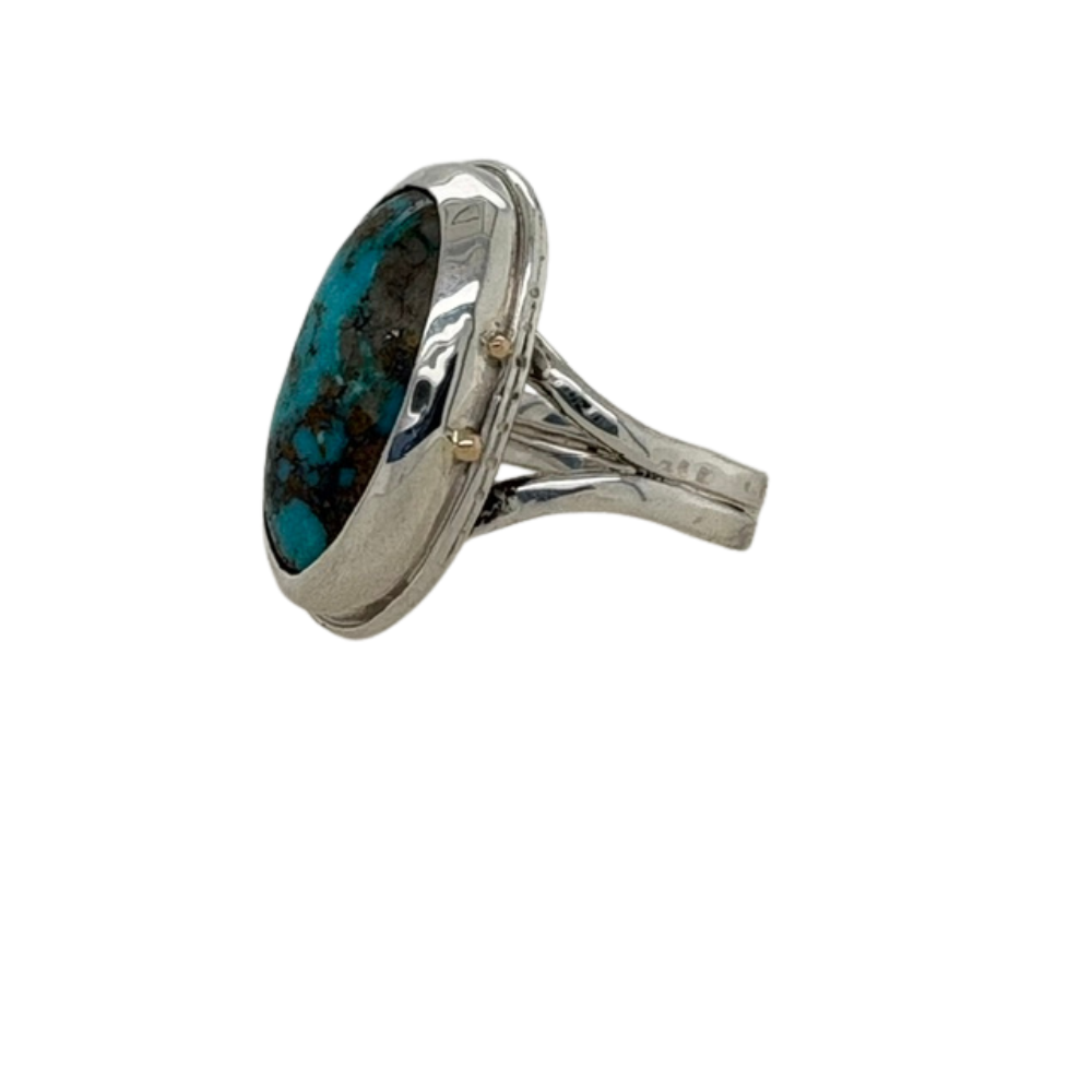 Persian Turquoise ring set in sterling silver with small 14K yellow gold accents.