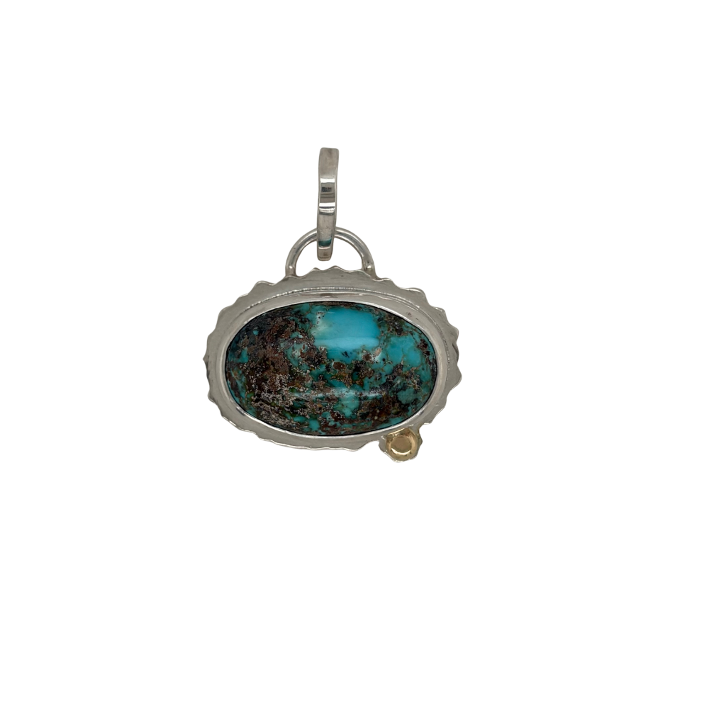 Persian Turquoise pendant set in sterling silver with a 14k yellow gold accent.