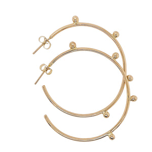 Dreamcatcher hoop earrings in gold.
