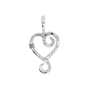 Hammered heart pendant in sterling silver.
