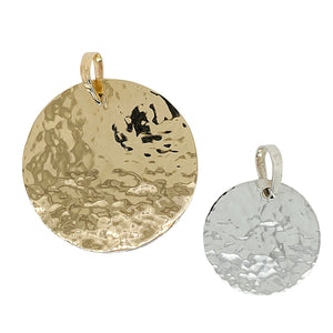 Hammered disc pendant in 14 kt gold and sterling silver.