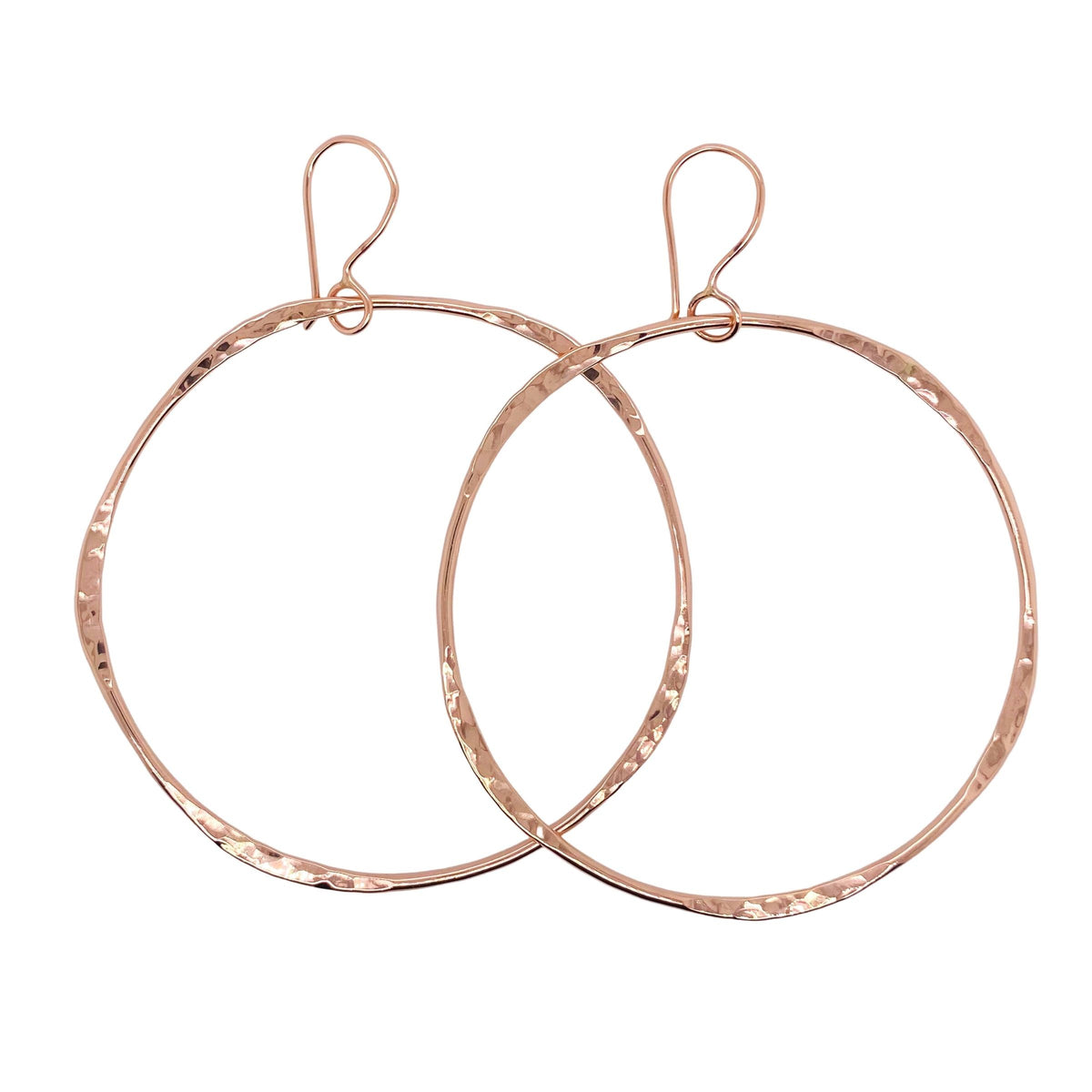 Hammered hoop earrings in rose gold.